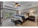 Spacious main bedroom with tray ceiling, large windows, and neutral carpet and walls at 317 Briarfield Dr, Apex, NC 27502