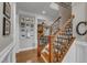 Elegant staircase featuring hardwood steps and wrought iron railings at 317 Briarfield Dr, Apex, NC 27502
