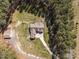 An aerial shot capturing the house layout with driveway, complemented by lush surrounding greenery at 3220 Brassfield Rd, Creedmoor, NC 27522
