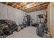 Unfinished basement area with exercise equipment and open space at 3220 Brassfield Rd, Creedmoor, NC 27522