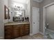 Bathroom featuring a granite vanity, a large mirror, and tile flooring at 3220 Brassfield Rd, Creedmoor, NC 27522