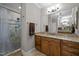 Stylish bathroom with walk-in shower, tile floors and dual vanity at 3220 Brassfield Rd, Creedmoor, NC 27522