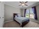 Cozy bedroom with plush carpet, natural light, and purple accents at 3220 Brassfield Rd, Creedmoor, NC 27522