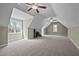 Large bonus room with vaulted ceilings, two ceiling fans and windows for natural light at 3220 Brassfield Rd, Creedmoor, NC 27522
