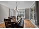 An elegant dining area features hardwood floors, large windows, and a modern chandelier at 3220 Brassfield Rd, Creedmoor, NC 27522