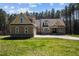 Charming exterior of home with well-manicured lawn, featuring a three car garage and a matching storage building at 3220 Brassfield Rd, Creedmoor, NC 27522