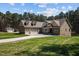 Charming exterior of home with well-manicured lawn, featuring a three car garage and a matching storage building at 3220 Brassfield Rd, Creedmoor, NC 27522