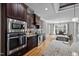 Chef's kitchen with stainless steel appliances and an adjacent dining area for easy entertaining at 3220 Brassfield Rd, Creedmoor, NC 27522