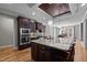 Open-concept kitchen with stainless steel appliances and a large island, perfect for cooking and gathering at 3220 Brassfield Rd, Creedmoor, NC 27522
