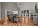 Cozy living room features hardwood floors, a fireplace, and an open layout to the kitchen at 3220 Brassfield Rd, Creedmoor, NC 27522