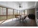 Relaxing screened-in porch with ceiling fan, table and grill at 3220 Brassfield Rd, Creedmoor, NC 27522