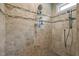 Modern tiled shower with rainfall showerhead and convenient shelving at 3220 Brassfield Rd, Creedmoor, NC 27522