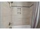 Shower stall with tiled walls, built-in shelf, and modern fixtures with a shower curtain at 3220 Brassfield Rd, Creedmoor, NC 27522