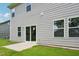 Backyard showing sliding glass doors leading onto a concrete patio surrounded by green grass at 3849 Rosebush Dr, Zebulon, NC 27597