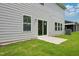 Backyard showing a concrete patio, sliding glass doors, and green grass at 3849 Rosebush Dr, Zebulon, NC 27597