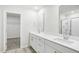 Bathroom with double vanity sinks, a large mirror, and a walk-in closet at 3849 Rosebush Dr, Zebulon, NC 27597