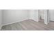 Empty bedroom with an ensuite bathroom, featuring modern flooring and neutral paint at 3849 Rosebush Dr, Zebulon, NC 27597