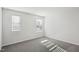 A light-filled room with soft gray carpet and two windows, ideal for creating a welcoming bedroom at 3849 Rosebush Dr, Zebulon, NC 27597