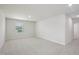 Large empty bedroom with light gray carpet and a bright window at 3849 Rosebush Dr, Zebulon, NC 27597