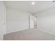 Neutrally decorated bedroom with light carpet and bright white walls at 3849 Rosebush Dr, Zebulon, NC 27597