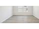 Bright empty bedroom with light gray plank flooring and natural lighting at 3849 Rosebush Dr, Zebulon, NC 27597