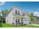 Beautiful two-story home with a covered porch, two-car garage, and a well-maintained lawn on a sunny day at 3849 Rosebush Dr, Zebulon, NC 27597