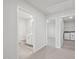 Hallway featuring carpet, a bathroom with modern fixtures and a laundry area with appliances at 3849 Rosebush Dr, Zebulon, NC 27597