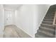 Entry hall with view of staircase and white front door at 3849 Rosebush Dr, Zebulon, NC 27597