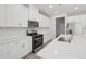 Modern kitchen featuring a large island, stainless steel appliances, and white cabinets at 3849 Rosebush Dr, Zebulon, NC 27597