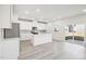 Contemporary kitchen with white cabinetry, center island, hardwood floors, and stainless appliances at 3849 Rosebush Dr, Zebulon, NC 27597