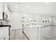 Bright, white kitchen featuring a center island, stainless appliances, and hardwood floors at 3849 Rosebush Dr, Zebulon, NC 27597