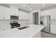 Bright kitchen with stainless steel appliances, white cabinets and quartz countertops at 3849 Rosebush Dr, Zebulon, NC 27597