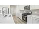 Well-appointed kitchen featuring stainless steel appliances, a gas range, and ample countertop space at 3849 Rosebush Dr, Zebulon, NC 27597