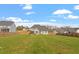 An overview of the spacious backyard enclosed by a wooden fence offering ample space for outdoor activities at 45 Melody Dr, Youngsville, NC 27596