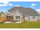 Expansive backyard featuring a screened porch, patio with outdoor seating, and lush green lawn at 45 Melody Dr, Youngsville, NC 27596