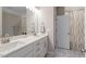 Well-lit bathroom with a double vanity and a separate shower area at 45 Melody Dr, Youngsville, NC 27596