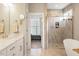 Bright bathroom with a double vanity, glass shower and stand-alone soaking tub at 45 Melody Dr, Youngsville, NC 27596