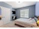 Serene bedroom with a neutral color scheme, comfortable bed, and natural light at 45 Melody Dr, Youngsville, NC 27596