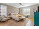 This bedroom boasts bright natural light with a neutral color palette and stylish ceiling fan at 45 Melody Dr, Youngsville, NC 27596