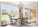 Sunny dining area featuring a large window, dining table with six chairs, and a sliding glass door at 45 Melody Dr, Youngsville, NC 27596