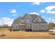 Charming gray two-story home with classic architecture, complemented by a well-kept lawn, on a sunny day at 45 Melody Dr, Youngsville, NC 27596