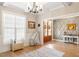 Inviting foyer showcases hardwood floors, decorative wall paneling, and access to other rooms at 45 Melody Dr, Youngsville, NC 27596