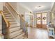 Inviting home foyer features hardwood floors, staircase, and double entry doors at 45 Melody Dr, Youngsville, NC 27596