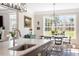 Open concept kitchen with island sink and breakfast bar next to dining area and large windows at 45 Melody Dr, Youngsville, NC 27596