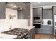 This kitchen features gray cabinets, stainless steel appliances, a gas range and white subway tile backsplash at 45 Melody Dr, Youngsville, NC 27596
