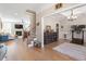 Open-concept living room leading to office and staircase, featuring hardwood floors and natural light at 45 Melody Dr, Youngsville, NC 27596