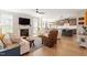 Bright living room features a fireplace, hardwood floors, and a view into the dining and kitchen areas at 45 Melody Dr, Youngsville, NC 27596