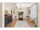 Bright office space with natural light, hardwood floors, and a stylish chandelier at 45 Melody Dr, Youngsville, NC 27596