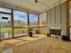 Relaxing screened porch with fireplace, offering views of the wooded backyard at 45 Melody Dr, Youngsville, NC 27596