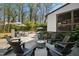Beautiful backyard showcasing a fire pit, outdoor seating, a lush lawn, and elegant landscaping at 5004 Lakemont Dr, Raleigh, NC 27609